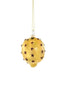 A textured yellow Christmas ornament shaped like a lemon, decorated with small dark brown cloves, hanging from a gold string against a solid white background.
